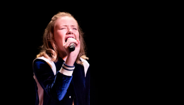 Girl With blue jacket singing