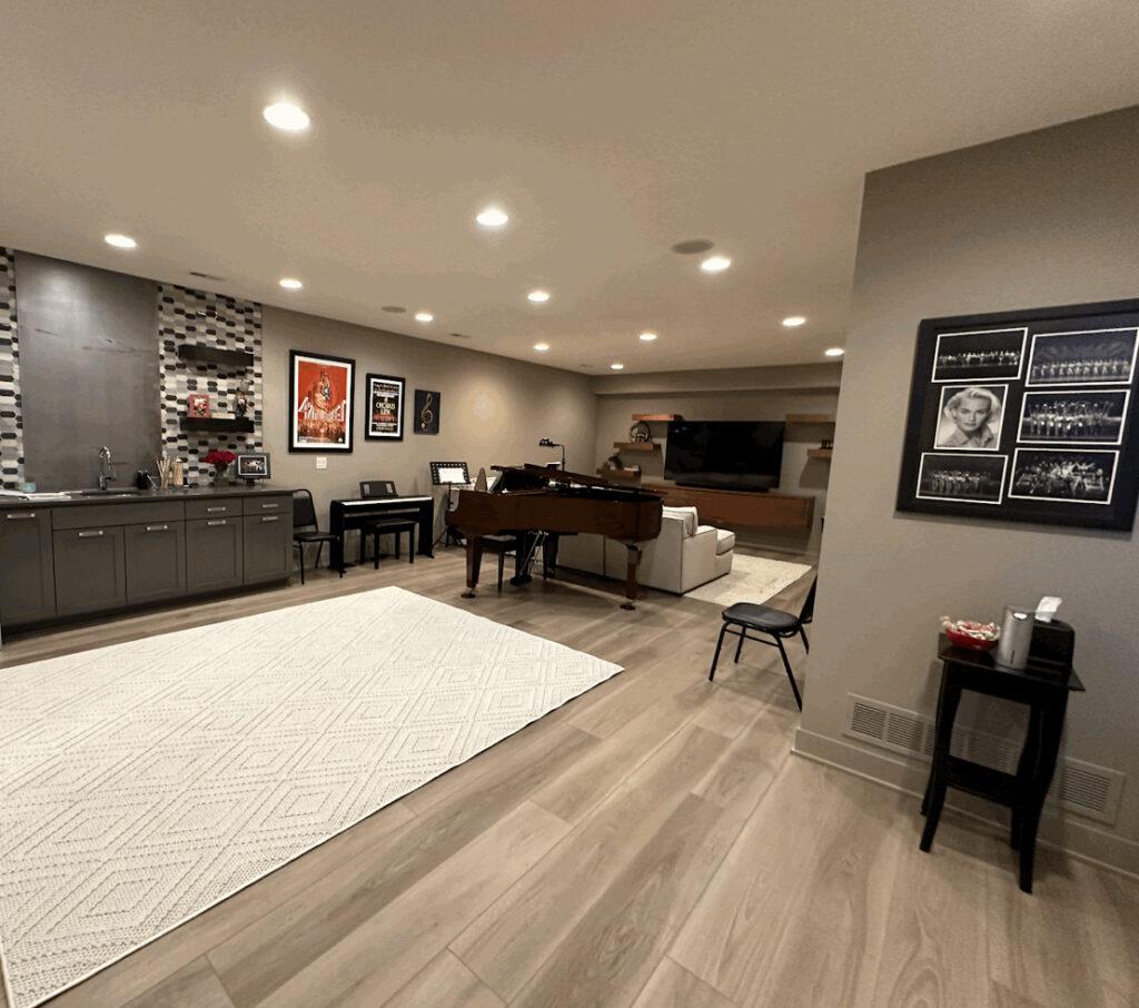 Stylish basement with piano and seating area.