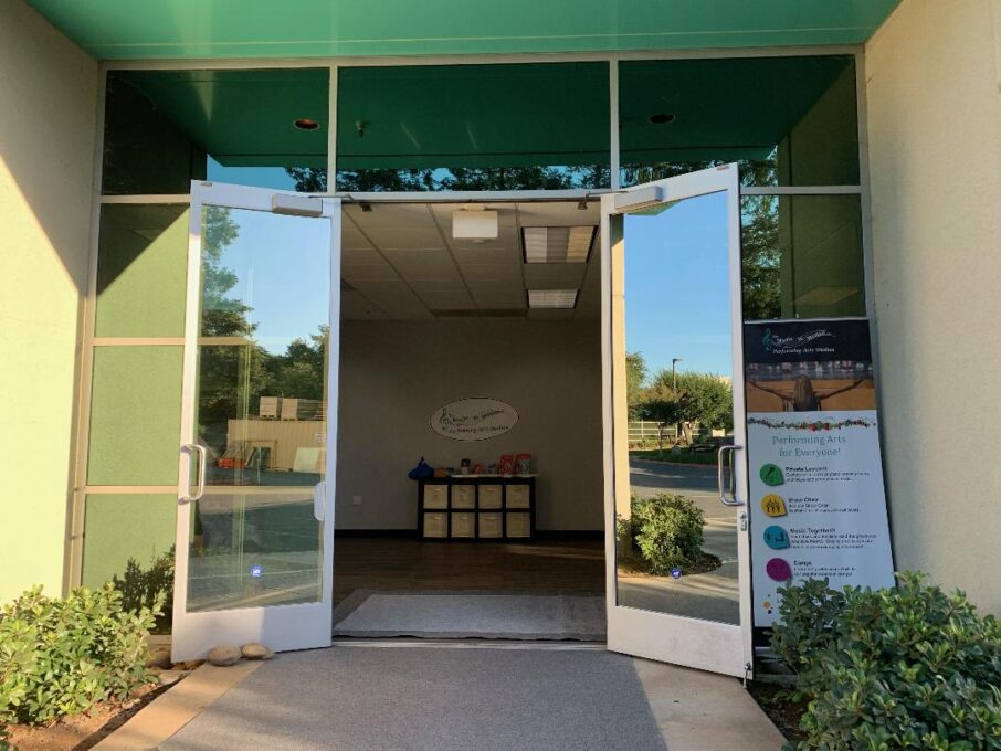 Open glass doors leading into a building.