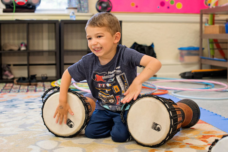 kid playing two drums
