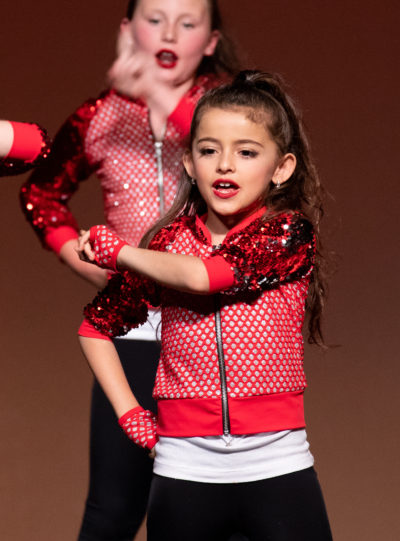 small girl dancing on stage