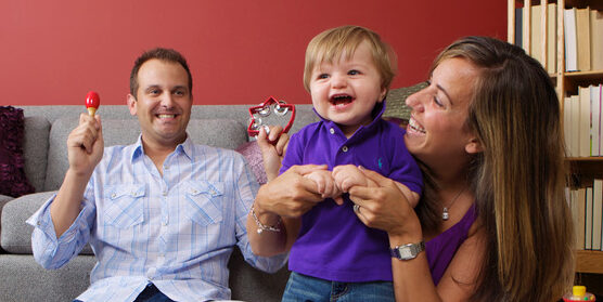 Baby laughing with parents