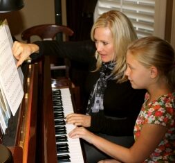 Woman Teaching piano to kids