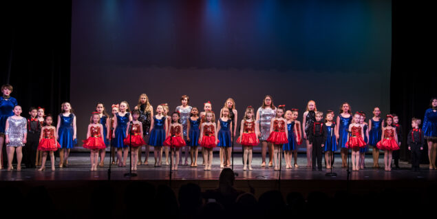 A group of boys and girls on the stage